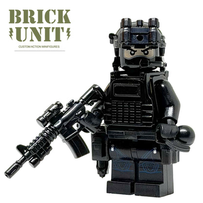 a custom lego special forces operator minifigure in all black uniform,with black balaclava head,fast helmet,tactical gear,holding a M4 CQB rifle.