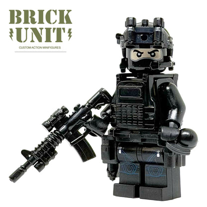 a custom lego special forces operator minifigure in all black uniform,with black balaclava head,fast helmet,tactical gear,holding a M4 CQB rifle.